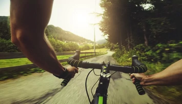 Bike race along a country road like how we're driven to impact healthcare company goals with market research